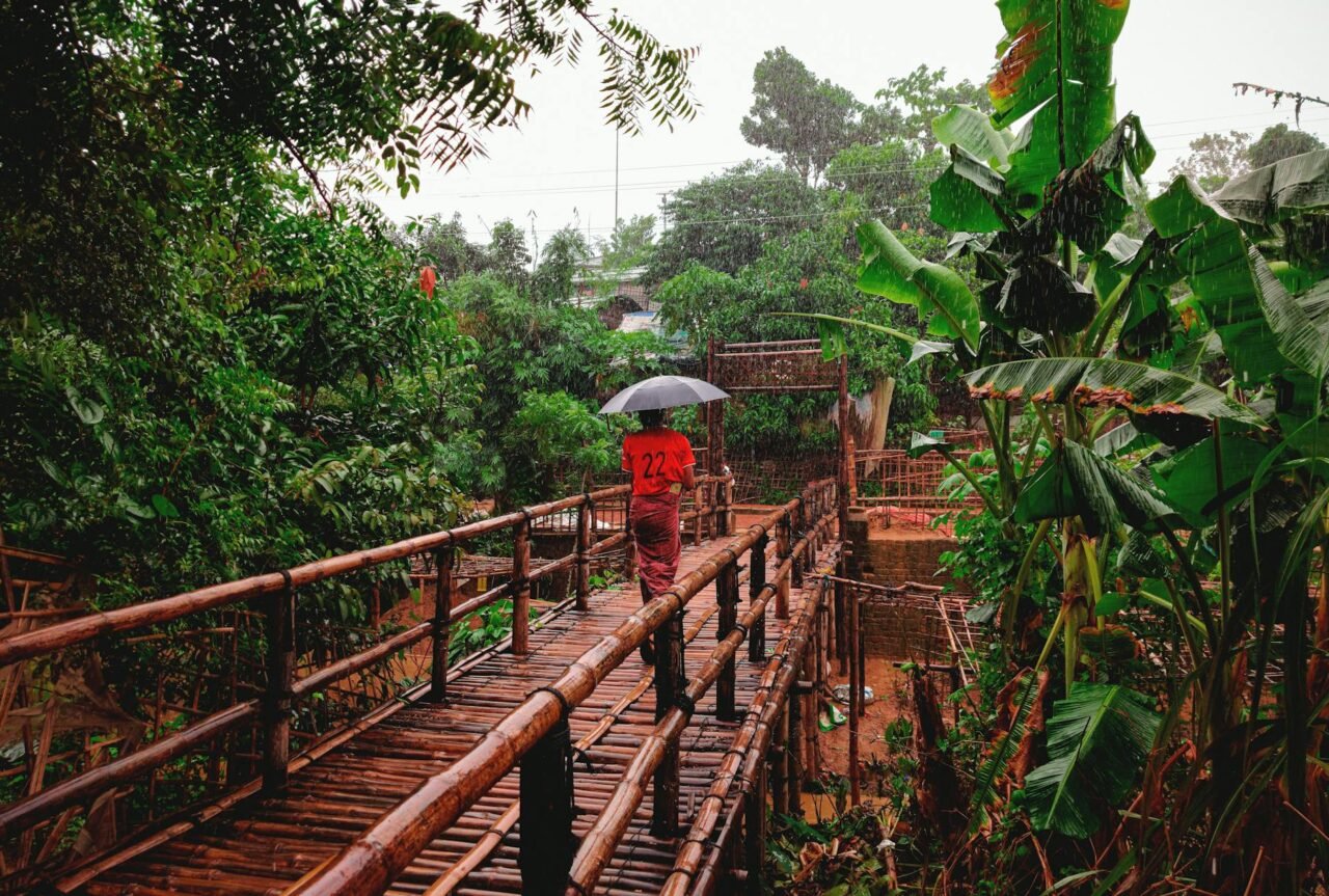 ceramic pots grouped under an eave with sand-filled trays.